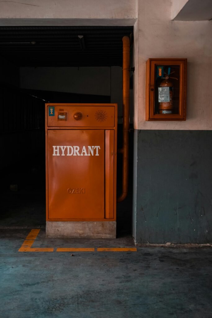 pexels-photo-6151200-6151200 Orange fire hydrant inside a building, offering safety and industrial vibe.